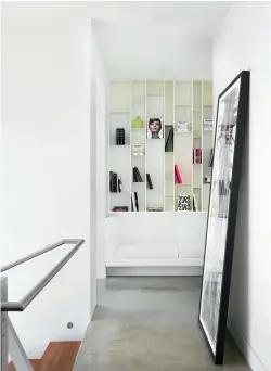  ??  ?? Lofty Ambitions Stairs to the upstairs sleeping area (top left) climb up while the main floor itself steps down, preserving high ceilings. A floor-toceiling shelving unit (top right) is only partly filled, in keeping with the homeowners’ desire to maintain clean lines and a sense of unrushed living. Ceramica Natural Trend tiling (bottom left) complement­s concrete and white walls perfectly.