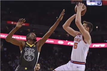  ?? JOSE CARLOS FAJARDO — BAY AREA NEWS GROUP ?? Dragan Bender (35), at right shooting over former Warrior Kevin Durant in February 2018, was signed by the Warriors to a 10-day contract on Thursday.
