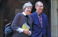  ?? PETER NICHOLLS / REUTERS ?? Britain's Prime Minister Theresa May and her husband Philip leave church in her constituen­cy near Reading, England, on Sunday.