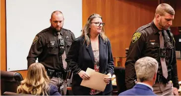  ?? Jeff Kowalsky/AFP/Getty Images/TNS ?? Jennifer Crumbley, 43, the mother of accused Oxford High School gunman Ethan Crumbley, leaves the courtroom in Pontiac, Mich., during a break in her trial Friday.