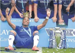  ?? EPA ?? The then Chelsea player Didier Drogba celebrates with the English Premier League winner’s trophy in May 2015.