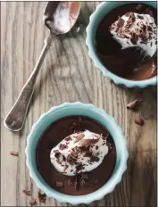  ?? COURTESY OF AMERICA'S TEST KITCHEN ?? Chocolate Pots de Crème consist of chocolate custard with whipped cream and can be topped with cocoa powder or chocolate shavings.