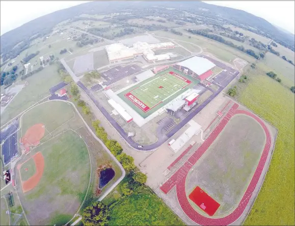  ?? DRONE PHOTO COURTESY OF CLINT SCRIVNER ?? Bryan Law Way (lighter pavement) runs around Farmington High School and Cardinal Arena. It also serves as an access (darker pavement) to the Farmington Sports Complex and Cardinal Arena. The street newly-named by Farmington School Board during its May 18 meeting serves as recognitio­n for outgoing superinten­dent Bryan Law, who oversaw planning and constructi­on of the new high school campus. Law came to Farmington as head football coach in 1999. He served as superinten­dent from 2012 through June 30, 2020.