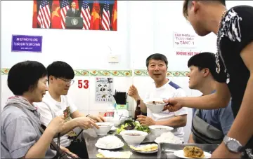  ??  ?? In this photograph taken on Mar 20, customers enjoy a meal at Bun Cha Huong Lien restaurant, now dubbed “bun cha Obama” with a photograph of former US President Barack Obama displayed on the wall, in Hanoi’s old quarter. — AFP photos by Nhac Nguyen