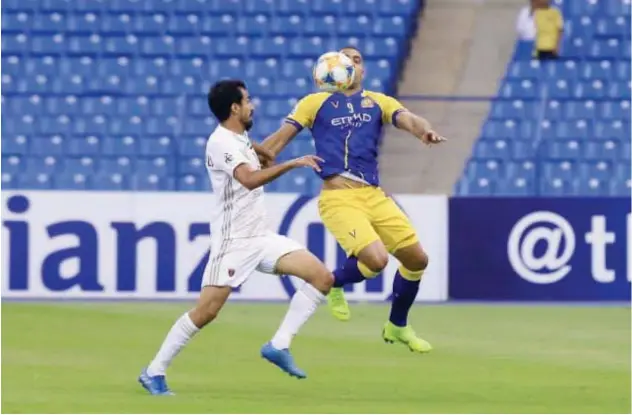  ??  ?? ↑ Al Wahda and Al Nassr players vie for the ball during their AFC Champions League match.