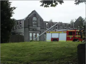  ??  ?? Fire crews remained at the scene on Wednesday morning. Photo: Eugene Cosgrove