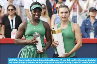  ?? — AFP ?? MONTREAL: Sloane Stephens (L) and Simona Halep of Romania (R) hold their trophies after competing in the final round during day seven of the Rogers Cup at IGA Stadium on Sunday in Montreal, Quebec, Canada. Simona Halep of Romania defeated Sloane Stephens 7-6, 3-6, 6-4.