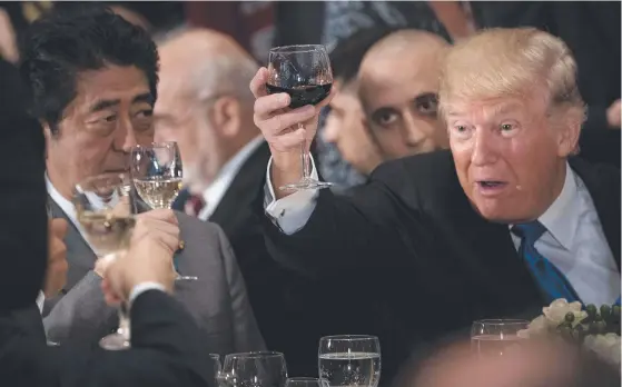  ?? Picture: AFP ?? Donald Trump raises his glass, joined by Japanese Prime Minister Shinzo Abe and other leaders,to a toast by UN Secretary-General Antonio Guterres.