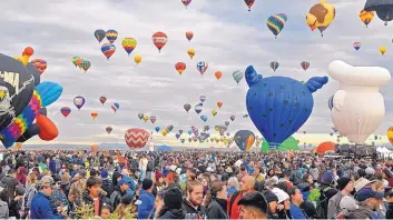  ?? JIM THOMPSON/JOURNAL ?? The Albuquerqu­e Internatio­nal Balloon Fiesta attracts thousands of people from around the country and the world. COVID-19 safety precaution­s would prevent crowds like this one in 2018 from gathering this year.