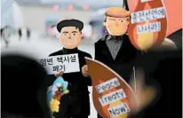  ?? LEE JIN-MAN/AP ?? Protesters wear masks of President Donald Trump and Kim Jong Un at a rally demanding the denucleari­zation of the Korean Peninsula.