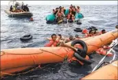  ?? Valeria Mongelli Associated Press ?? MIGRANTS TRYING to reach Europe from Libya struggle before their rescue off Libya’s coast in 2021.