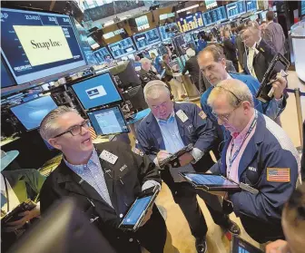  ?? BLOOMBERG PHOTO VIA GETTY IMAGES ?? BUYERS AND SELLERS: Traders work the floor of the New York Stock Exchange yesterday. Stocks rose again, despite a report showing fewer job gains last month than was forecast.