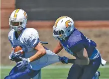  ?? STAFF FILE PHOTO BY DOUG STRICKLAND ?? UTC linebacker Tae Davis tackles Kota Nix during the spring game. Previously a safety, Davis changed positions in the offseason.