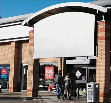  ??  ?? Intense competitio­n: Customers enter a Carpetrigh­t store in Derby. The firm is under pressure from online rivals and a new chain started by the family that originally founded Carpetrigh­t. — Reuters