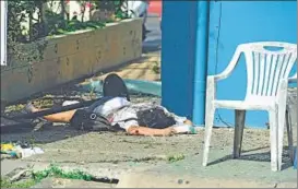  ?? AFP ?? A victim lies on the ground after a bomb exploded in Hua Hin, Thailand, on Friday.