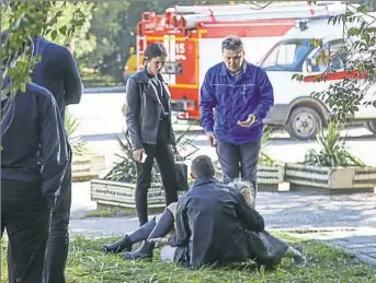  ??  ?? A rescuer carries an injured woman Wednesday at a college in the city of Kerch. At least 19 people died at a technical college on the Crimean peninsula, with dozens more injured.