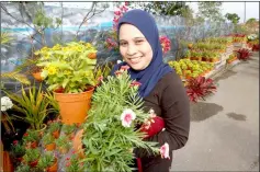  ??  ?? A woman shows her choice of plants from the open day. — Photos by Muhammad Rais Sanusi