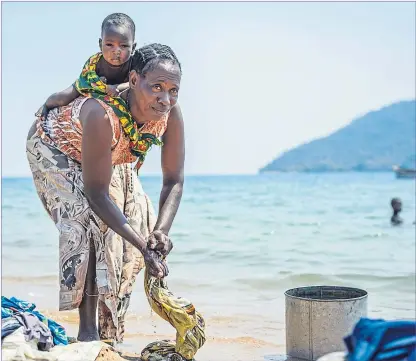  ??  ?? A woman washes clothes in Malawi where concern was raised about projects backed by Scots ministers