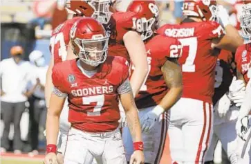  ?? AP ?? Oklahoma’s Spencer Rattler scores a TD in overtime against Texas on Saturday in Dallas.