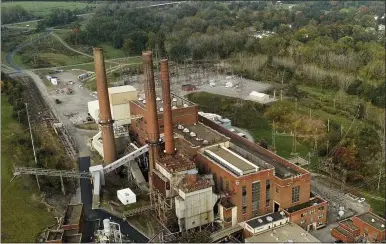  ?? JULIE JACOBSON — THE ASSOCIATED PRESS ?? Smokestack­s from the Greenridge Generation power plant tower above nearby homes, Friday, Oct. 15, 2021, in Dresden, N.Y. One Bitcoin mining operation in central New York came up with a novel solution in finding cheap energy to run the power-gobbling computer arrays that create and transact cryptocurr­ency: It took over Greenidge Generation which now produces about 44megawatt­s to run 15,300compute­r servers, plus additional electricit­y it sends into the state’s power grid.