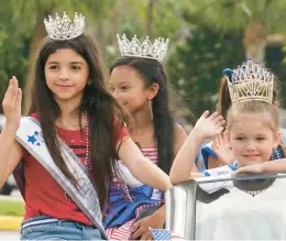  ?? MARTA LAVANDIER/AP ?? Members of the Florida Internatio­nal Girl pageant group wave during a Fourth of July parade Monday in Plantation, Fla., one of many holiday events across the U.S.