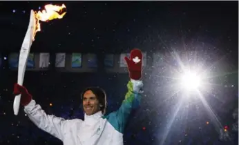  ?? MARK BAKER/THE ASSOCIATED PRESS FILE PHOTO ?? Steve Nash carries the torch during the opening ceremony for the 2010 Winter Olympics in Vancouver.