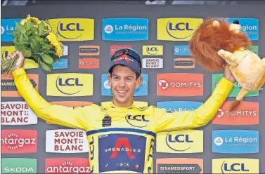  ??  ?? Richie Porte celebra vestido de amarillo su victoria en la general final del Dauphiné.