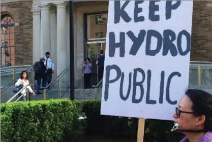  ?? KEEP HYDRO PUBLIC/TWITTER ?? People gather outside the MaRS building in Toronto protesting the privatizat­ion of Hydro One in May. “Of all the maladroit moves Wynne has made as premier, privatizin­g Hydro One is the worst,” writes Thomas Walkom.