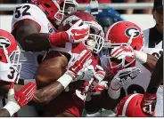  ?? (Democrat-Gazette file photo) ?? Arkansas running back Jonathan Williams is brought down by several Georgia defenders in 2014. The Bulldogs are 4-0 against the Razorbacks at Fayettevil­le.