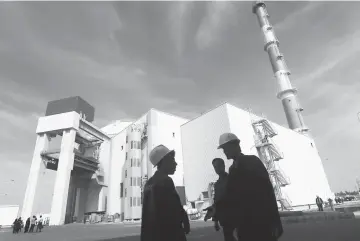  ??  ?? File photo shows Iranian workers stand in front of the Bushehr nuclear power plant, about 1,200 km south of Tehran. — Reuters photo