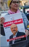  ?? AP PHOTO/FRANCOIS MORI ?? An activist holds a portrait reading "Friends of Khashoggi around the world" as part of a protest closed to the Saudi Arabia embassy, in Paris, Thursday.