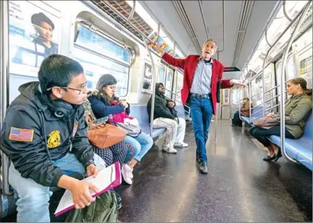  ?? AFP ?? Richard McLachlan delivers his message about climate change to commuters on the subway on October 17 in New York City.