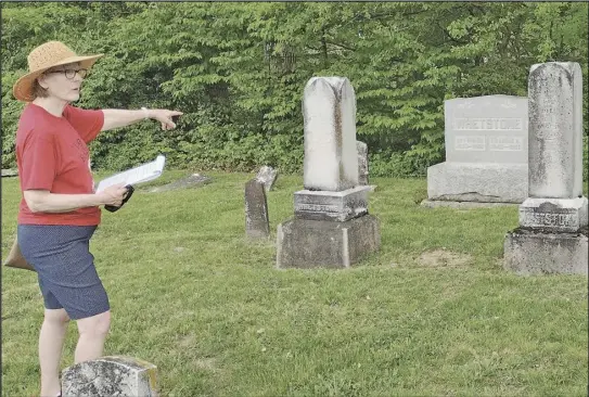  ?? ?? Joyce Pugh points out the final resting place for some of Buckland's earliest residents Saturday during a tour of
the Buckland Cemetery. The tour is part of the village's anniversar­y celebratio­n.