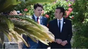  ?? STEPHANE DE SAKUTIN/AFP/GETTY IMAGES ?? Emmanuel Macron appeared to form a special bond with Justin Trudeau at the G7 summit in Italy.