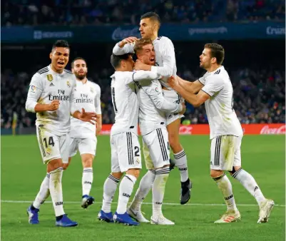  ??  ?? EUFORIA. Sergio Ramos levanta a Dani Ceballos, mientras sus compañeros celebran el gol de la victoria contra el Betis.