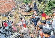  ?? PTI PHOTO ?? Rescue work is on at a site where a wall collapsed killing four people in Dehradun, Uttarakhan­d, on Wednesday.