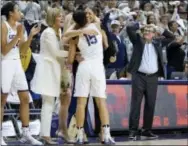  ?? JESSICA HILL — THE ASSOCIATED PRESS ?? Connecticu­t head coach Geno Auriemma, right, reacts as Connecticu­t’s Gabby Williams (15) is congratula­ted by associated head coach Chris Dailey and embraced by assistant coach Marisa Moseley at the end of Monday’s game against South Carolina.