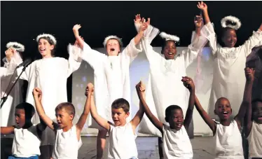  ?? ?? The ‘Children of the World’ sing songs to celebrate the birth of baby Jesus