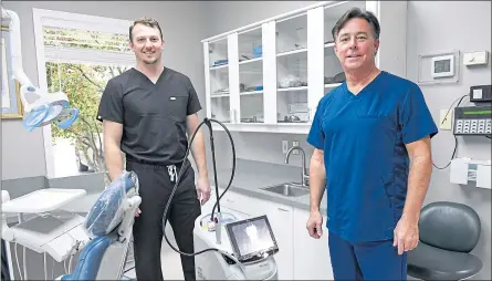  ?? BEN HASTY — READING EAGLE ?? Dr. Jon Angstadt and Dr. Eric R. Angstadt stand next to the Waterlase laser at Angstadt Family Dental in Wyomissing.