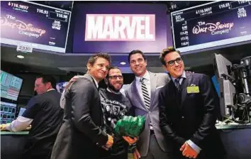  ?? AP ?? Marvel bell Actors Jeremy Renner (far left) and Robert Downey Jr (far right) after ringing the opening bell with Marvel Entertainm­ent executives (not shown) yesterday. US stocks rose on with the S&P touching a new intraday high and the Nasdaq closer to...