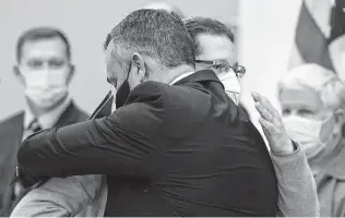  ?? Elias Valverde II / Dallas Morning News ?? Rabbi Charlie Cytron-Walker of Congregati­on Beth Israel, right, embraces Matthew J. DeSarno, special agent in charge of the Dallas FBI Field Office, during a Friday news conference.