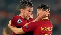  ?? GETTY IMAGES ?? Kevin Strootman and Kostas Manolas congratula­te each other after Roma stunned Barcelona.