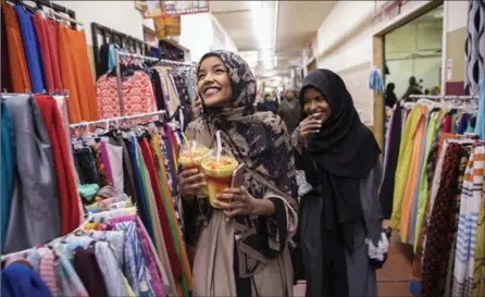  ?? LEILA NAVIDI, STAR TRIBUNE ?? Halima Aden, left, shops at a mall in Minneapoli­s with her friend Shamsa.