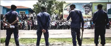  ??  ?? Police stand in front of supporters of Fayulu as they take part in a protest to contest presidenti­al election results. — AFP photo