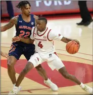  ?? (NWA Democrat-Gazette/Andy Shupe) ?? Arkansas freshman guard Davonte Davis dribbles against Auburn’s Allen Flanigan during the Razorbacks’ victory Wednesday night. Arkansas trailed by 19 points in the game, and it is believed to be the Hogs’ largest comeback at Walton Arena.