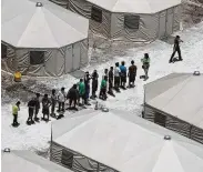  ?? Joe Raedle / Getty Images ?? Children and workers line up at a tent encampment recently built in Tornillo, near El Paso. The Trump administra­tion is using the facility to house boys separated from their parents.