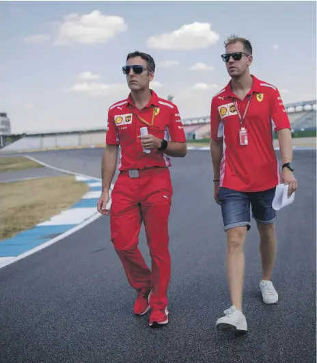  ?? EPA ?? Sebastian Vettel, right, surveys the Hockenheim­ring circuit track and plot strategy with a Ferrari colleague