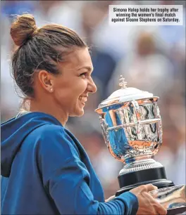  ??  ?? Simona Halep holds her trophy after winning the women's final match against Sloane Stephens on Saturday.