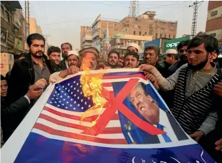  ?? AP ?? Traders in Peshawar protest the US decision to suspend military aid to Pakistan. Opposition leader Imran Khan has called for retaliator­y action, including measures that could affect the US-led coalition fighting in Afghanista­n.