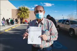  ??  ?? Bob Ellis holds up a thank you letter from a child during his drive-thru charity event. “This is what makes us do it right here,” he said.